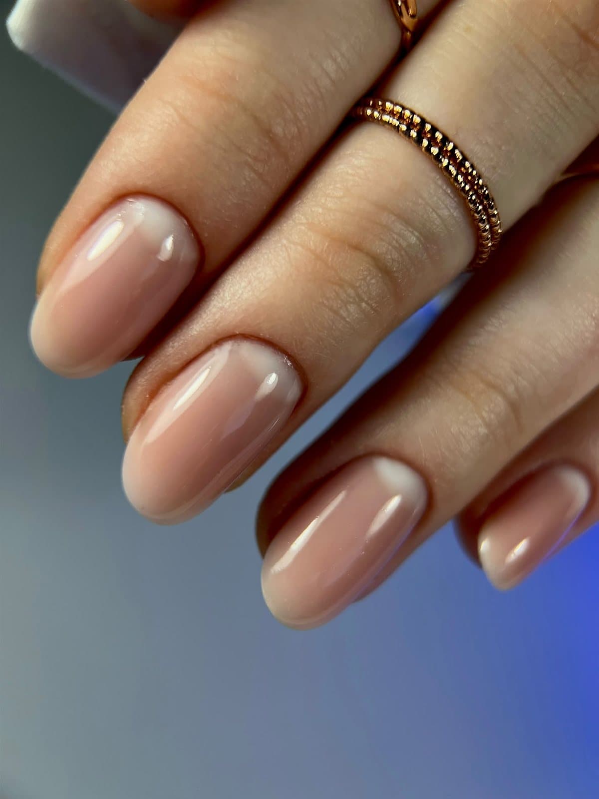 Nude nails styled with a fine ring