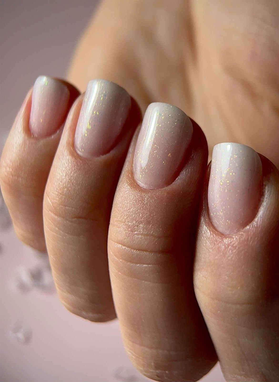 Milky-white pearly nails with gold shimmer